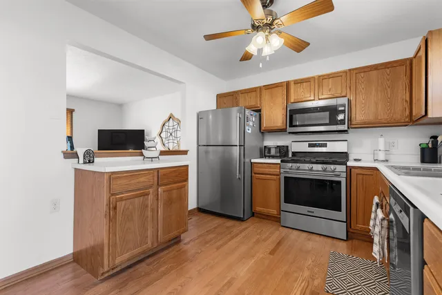 a kitchen with stainless steel appliances a refrigerator stove and microwave