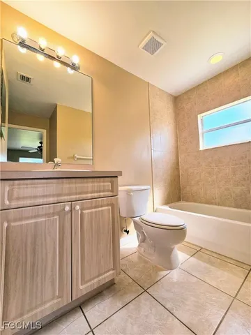 a bathroom with a toilet a sink and bathtub