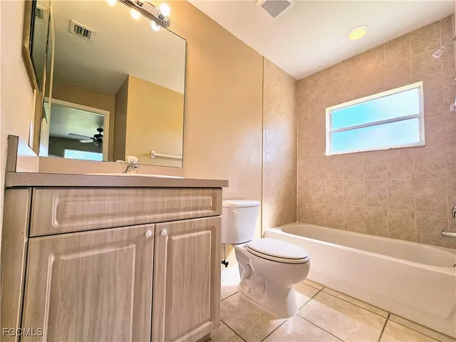 a bathroom with a toilet a sink and a mirror