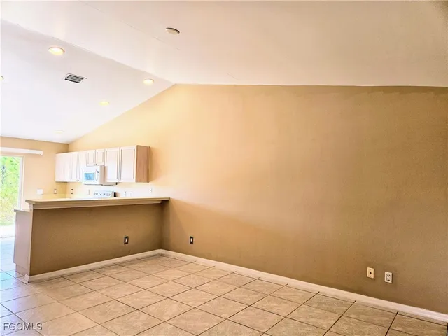 a view of kitchen and empty room