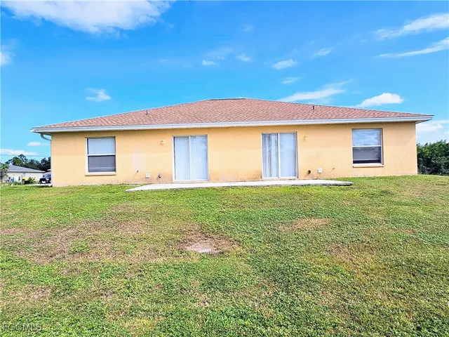 a front view of house with yard and green space