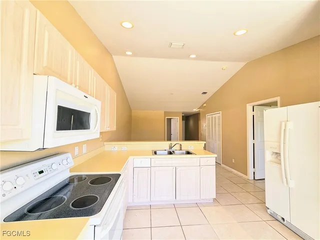 a kitchen with a sink appliances and cabinets