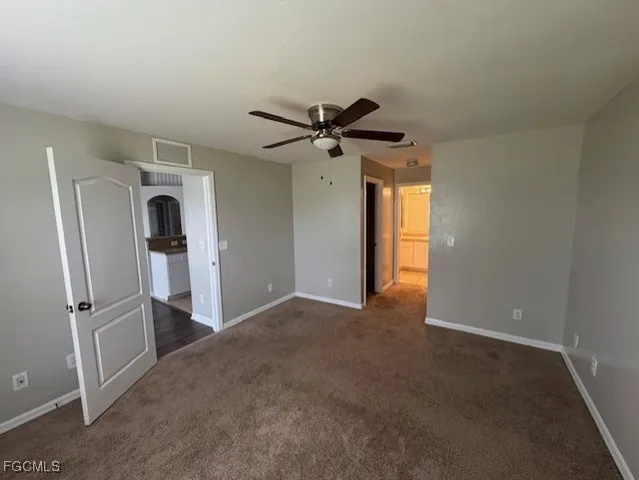 a view of a livingroom with a fireplace and a ceiling fan