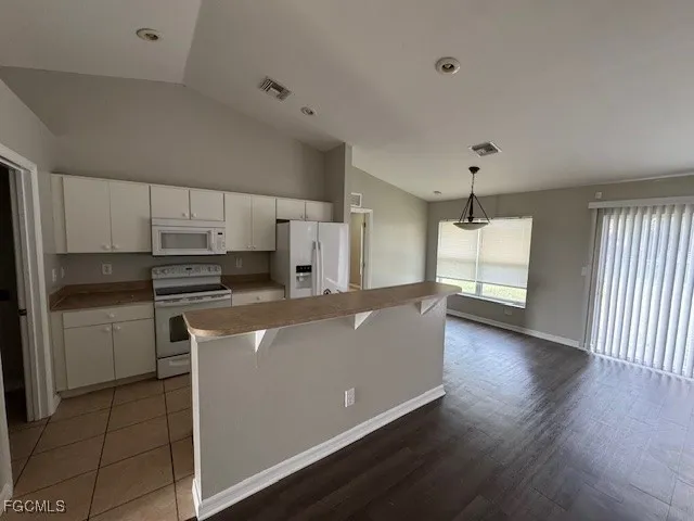 a kitchen with stainless steel appliances a refrigerator sink and cabinets