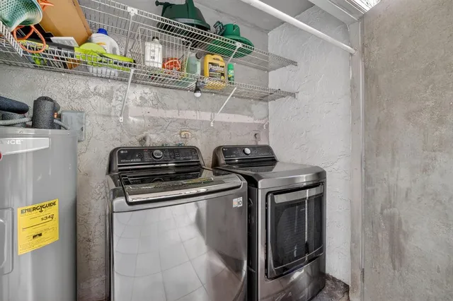 a backyard of a house with table and chairs plants and large trees