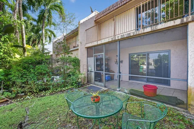 a car parked in front of a house with a yard