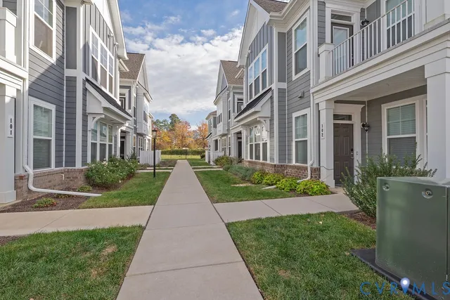 front view of a brick house with a yard