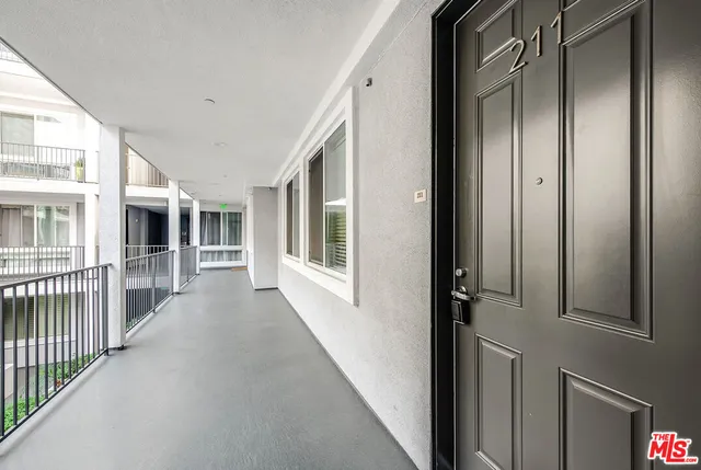 view of a porch with wooden floor and stairs
