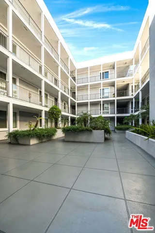 a front view of a building with a garden