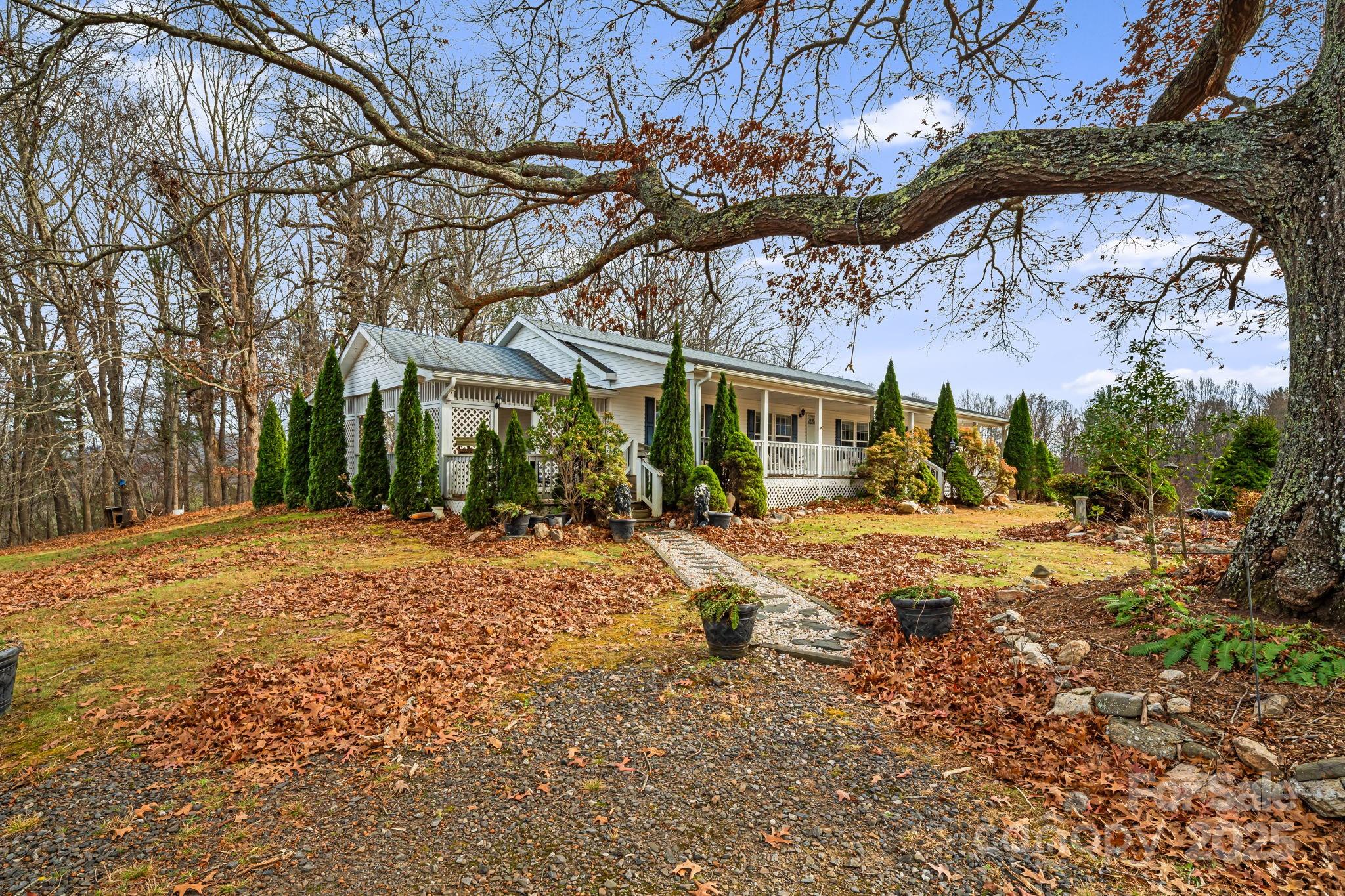 686 Sam Jones Road Burnsville, NC 28714 - Photo 1 of 41 a house with trees in the background