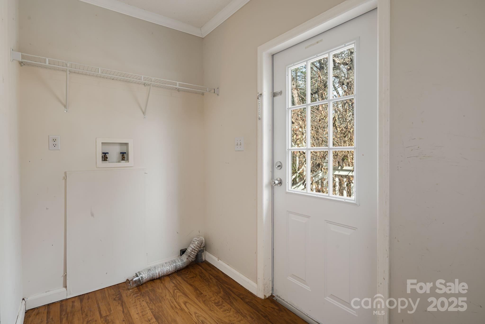 686 Sam Jones Road Burnsville, NC 28714 - Photo 14 of 41 a view of an empty room with wooden floor and a window