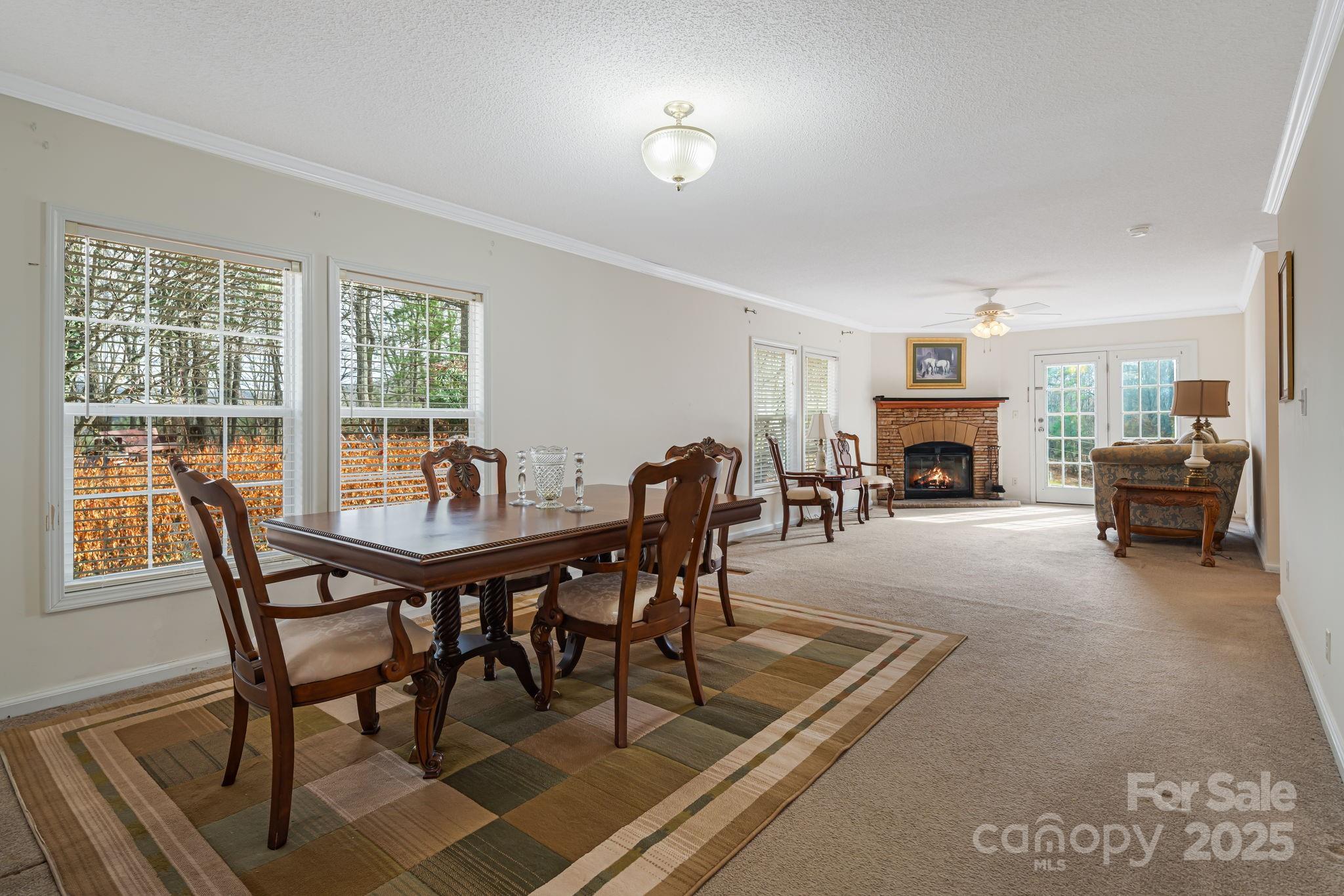 686 Sam Jones Road Burnsville, NC 28714 - Photo 15 of 41 a view of a dining room with furniture and a fireplace