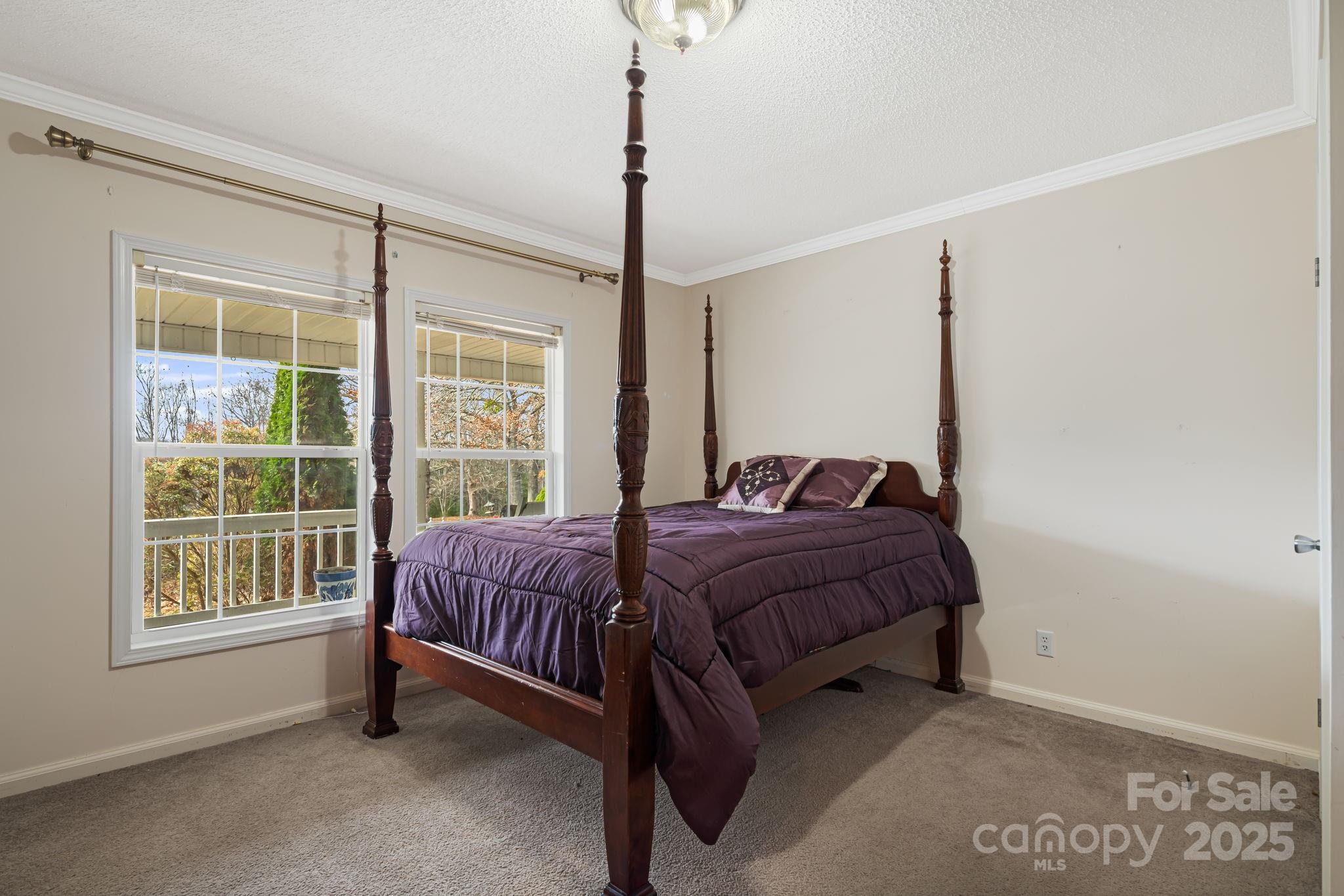 686 Sam Jones Road Burnsville, NC 28714 - Photo 22 of 41 a bed sitting in a room next to a window
