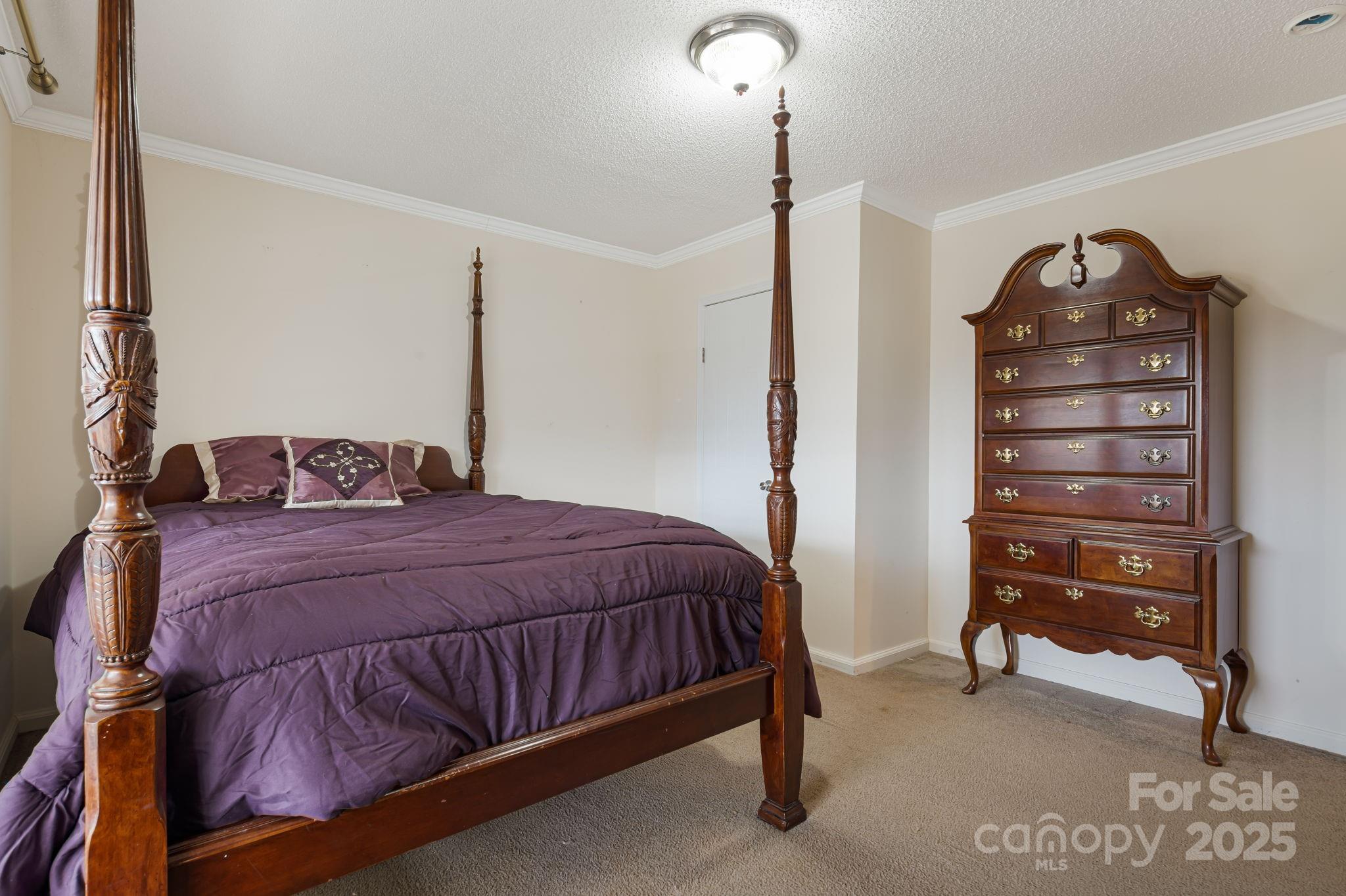 686 Sam Jones Road Burnsville, NC 28714 - Photo 23 of 41 a bedroom with a bed and a dresser