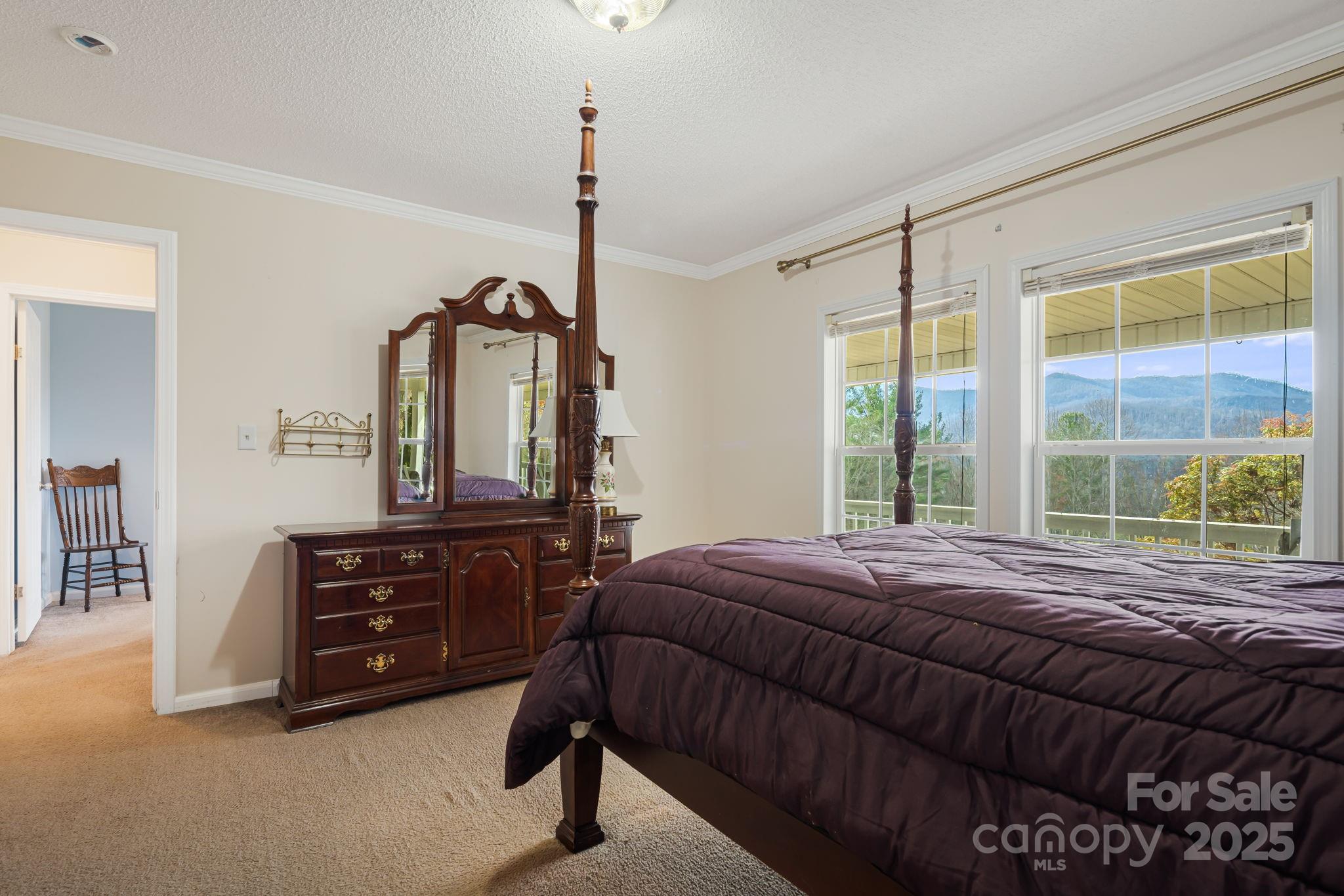 686 Sam Jones Road Burnsville, NC 28714 - Photo 24 of 41 a bedroom with a bed a dresser and mirror