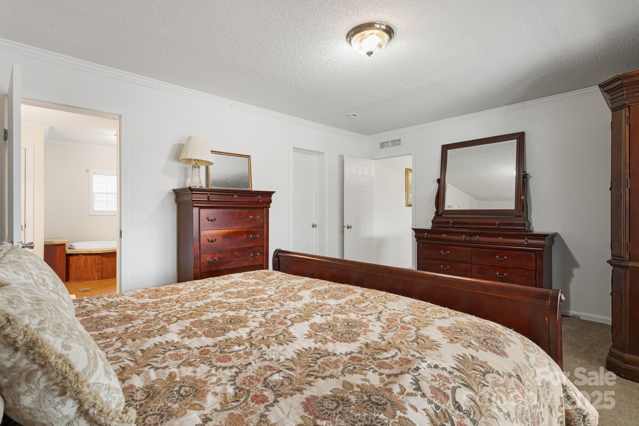686 Sam Jones Road Burnsville, NC 28714 - Photo 26 of 41 a bedroom with a bed and dresser