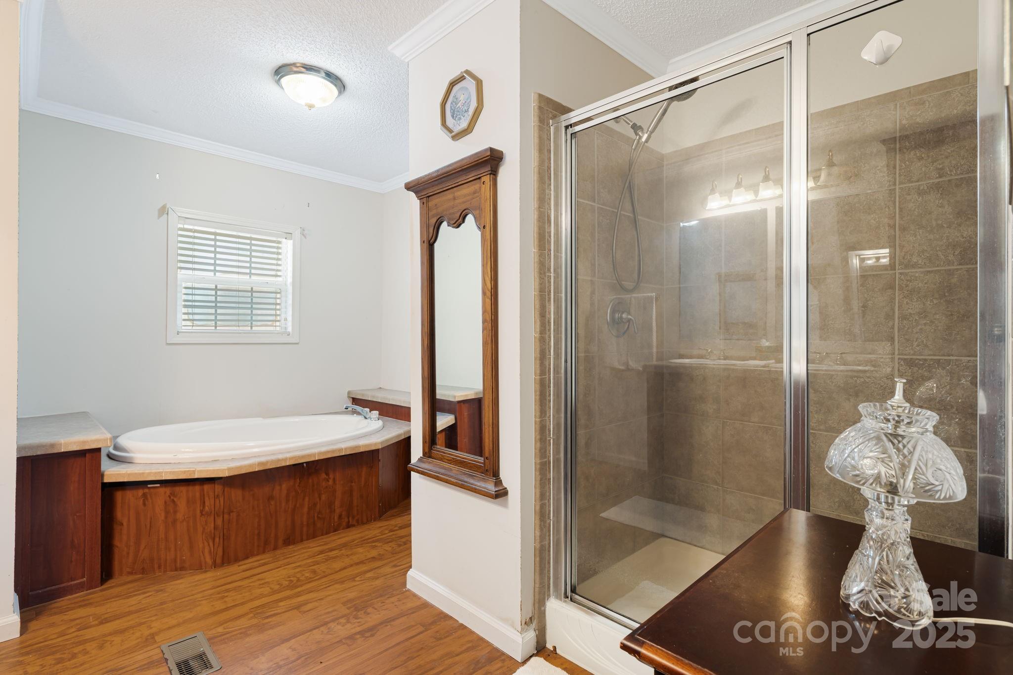 686 Sam Jones Road Burnsville, NC 28714 - Photo 27 of 41 a bathroom with a tub shower and sink
