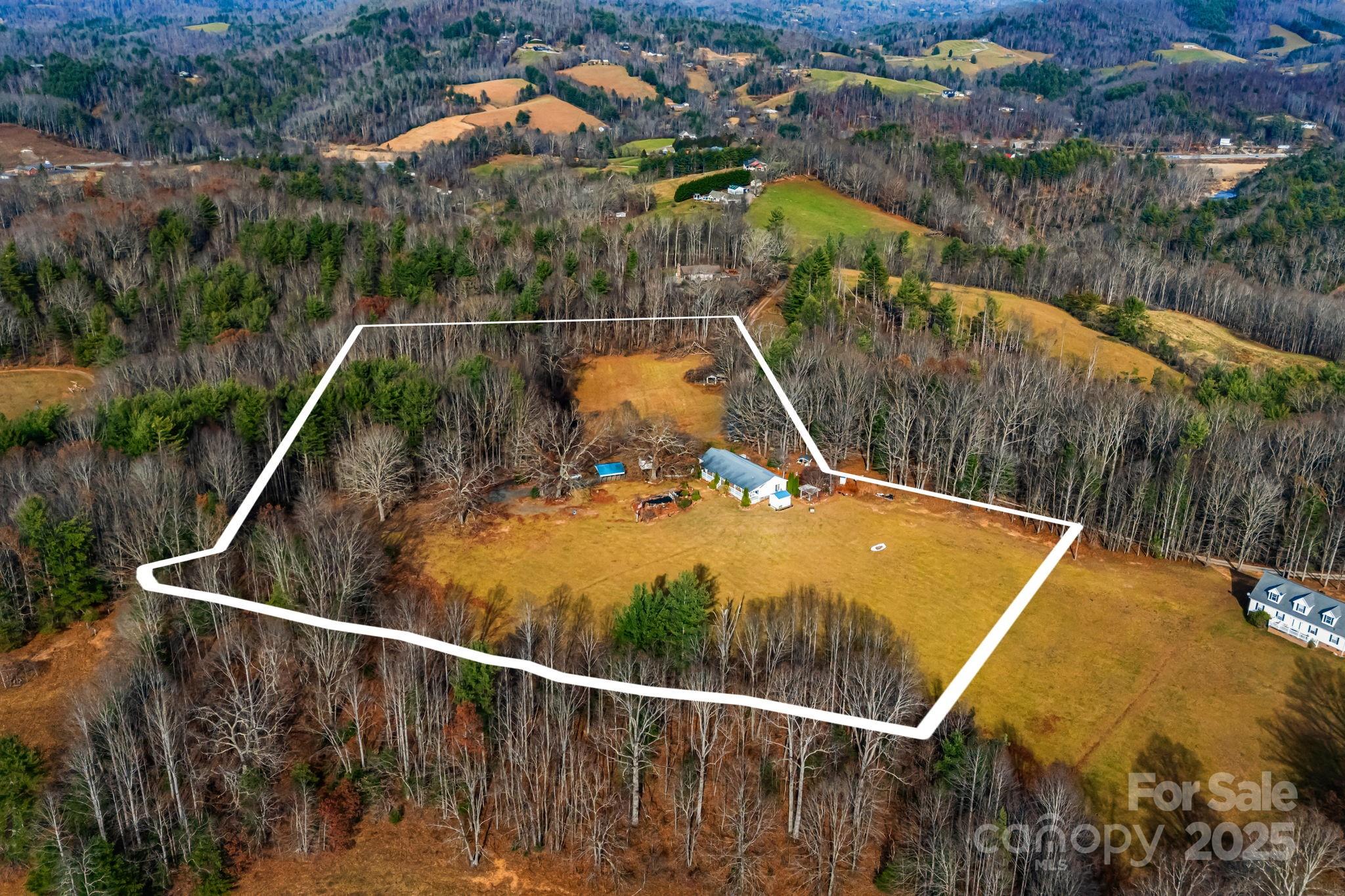 686 Sam Jones Road Burnsville, NC 28714 - Photo 35 of 41 a view of a swimming pool with a yard and lake view