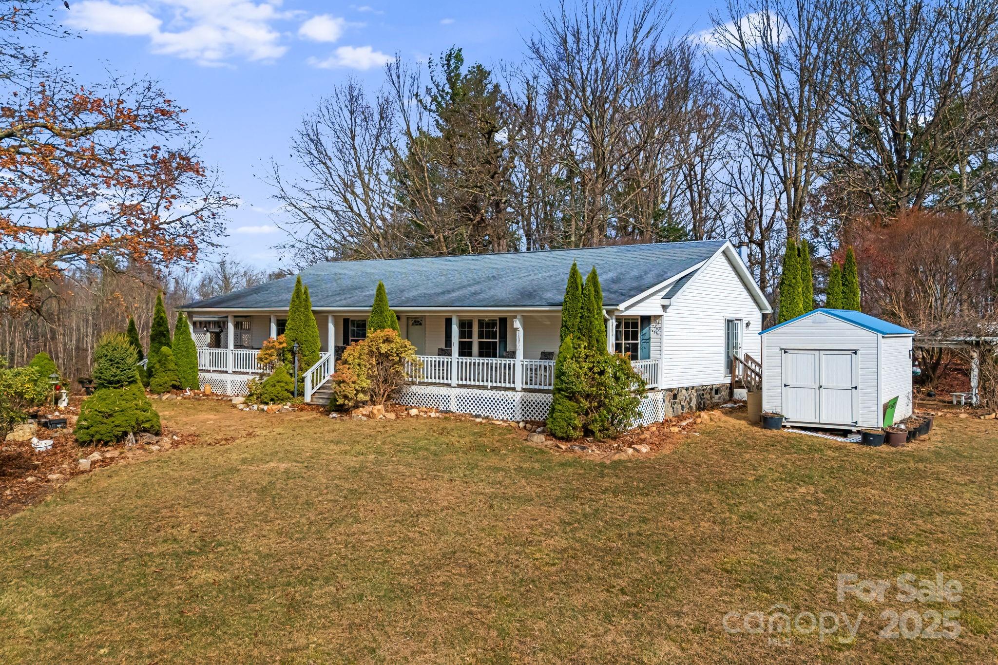 686 Sam Jones Road Burnsville, NC 28714 - Photo 5 of 41 a view of a house with backyard and a tree