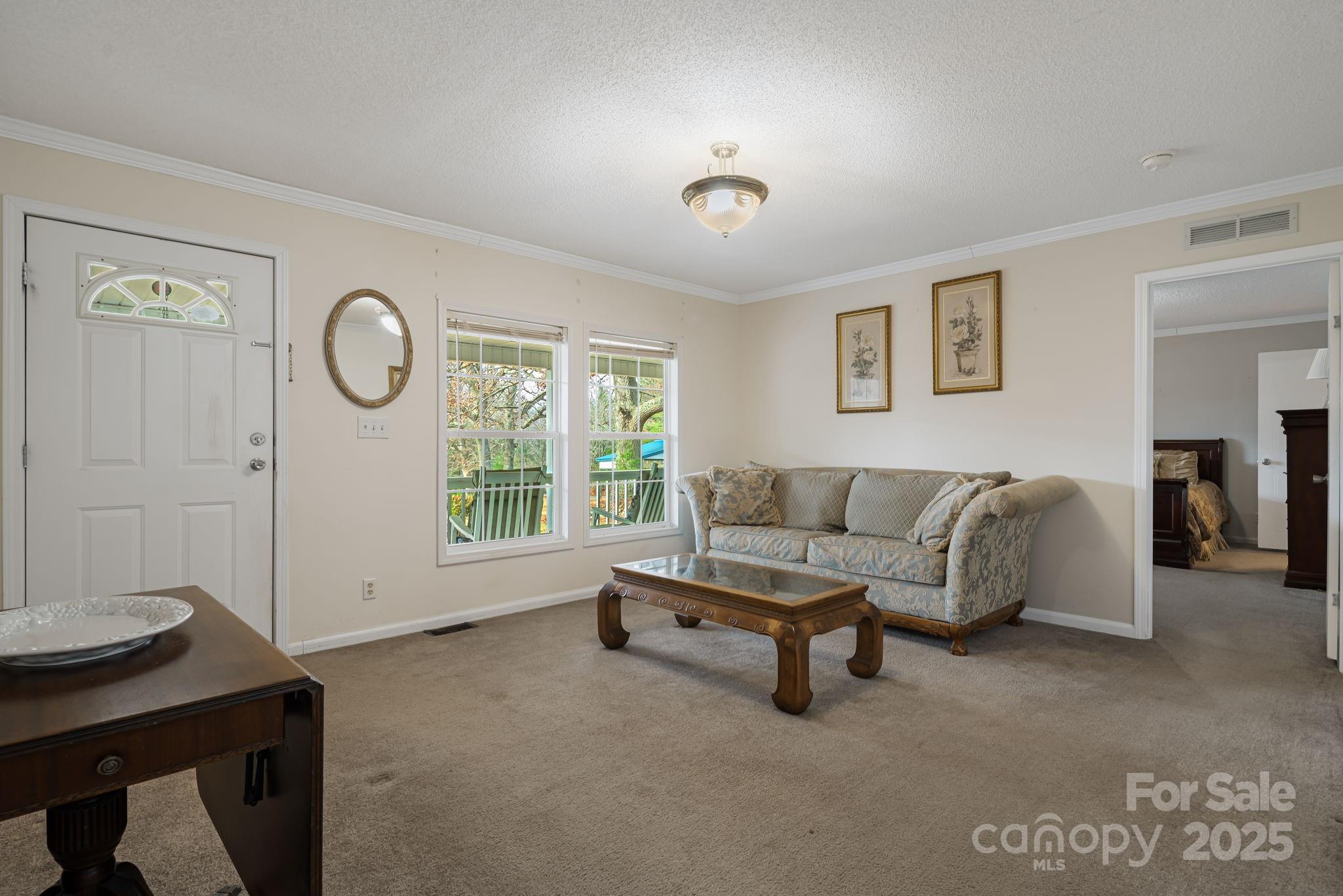 686 Sam Jones Road Burnsville, NC 28714 - Photo 9 of 41 a living room with furniture a table and a window