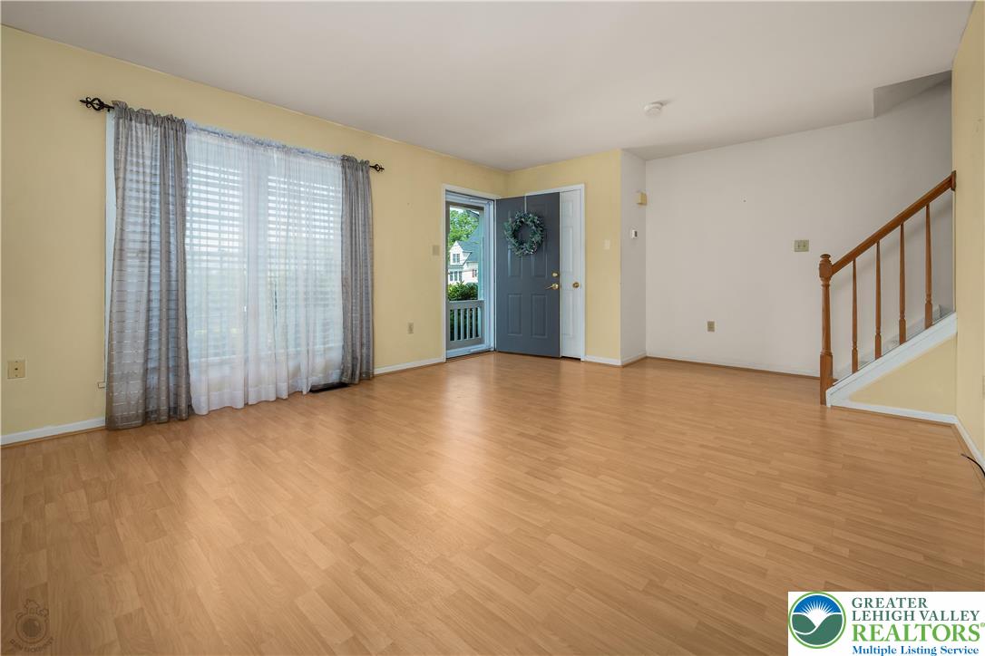 1514 Ravena Street Bethlehem, PA 18015 - Photo 4 of 18 a view of an empty room with wooden floor and a window
