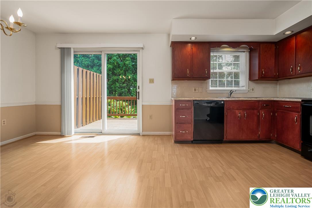1514 Ravena Street Bethlehem, PA 18015 - Photo 8 of 18 a large kitchen with wooden cabinets and a wooden floor