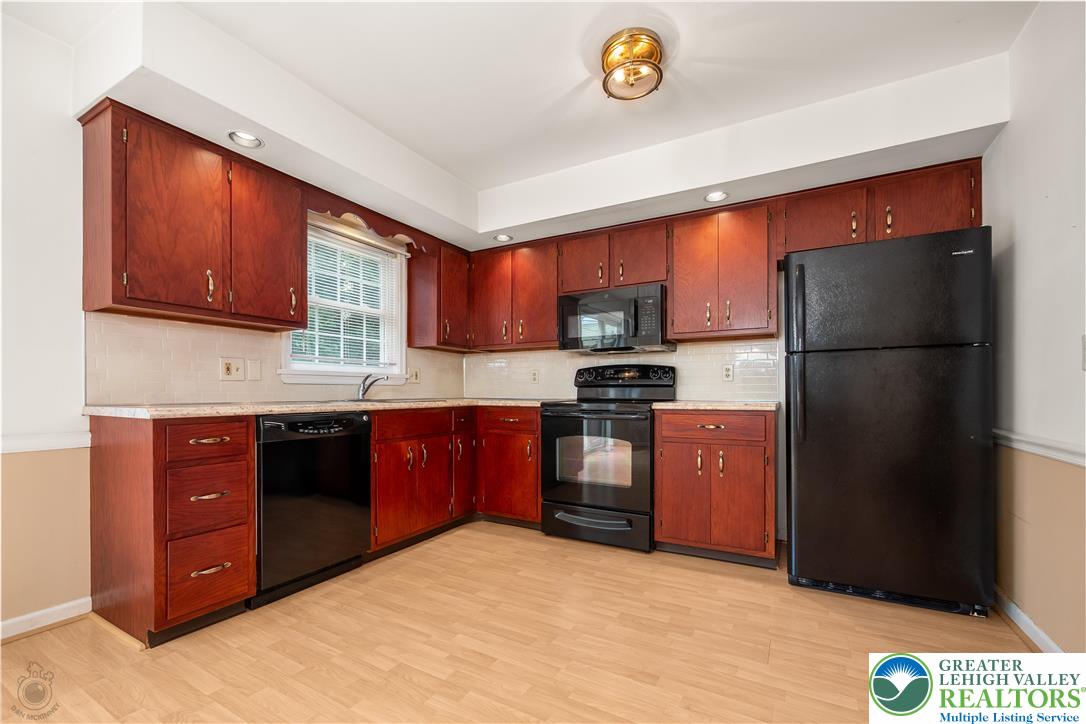 1514 Ravena Street Bethlehem, PA 18015 - Photo 9 of 18 a kitchen with stainless steel appliances granite countertop a refrigerator stove and oven