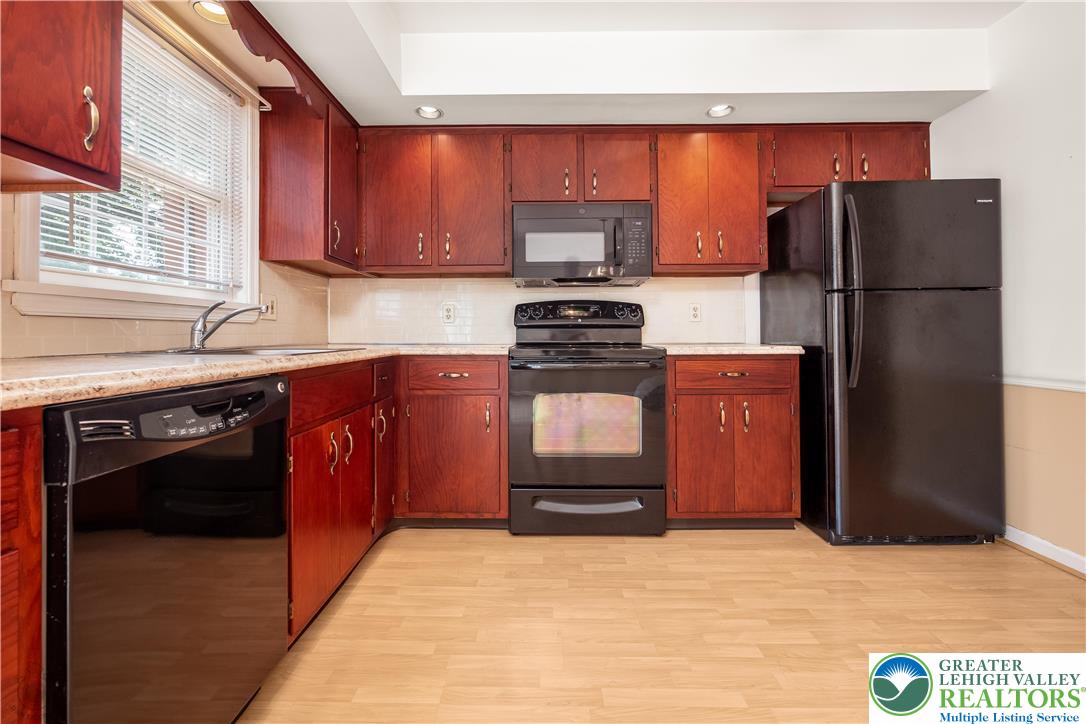 1514 Ravena Street Bethlehem, PA 18015 - Photo 10 of 18 a kitchen with stainless steel appliances granite countertop a refrigerator stove and sink