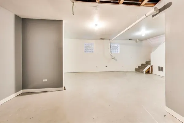 an empty room with closet and windows