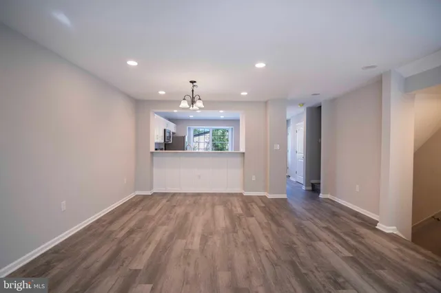 a view of a kitchen with wooden floor and kitchen