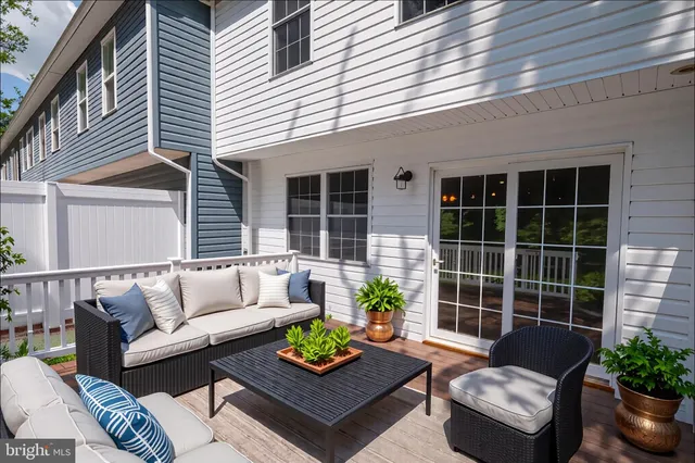a view of a patio with couches and a potted plant