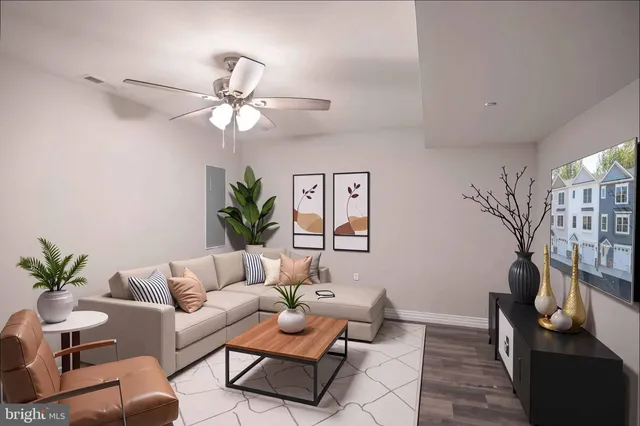 a living room with furniture and a potted plant