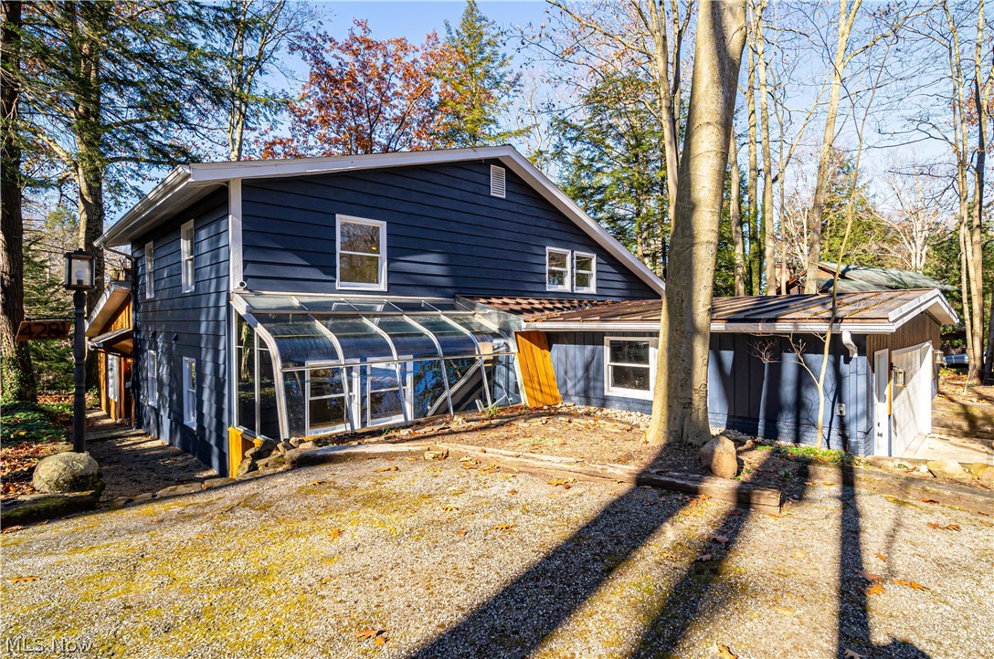 4281 North Forest Ridge Drive Ashtabula, OH 44004 - Photo 2 of 34 Side view from street. Side of garage, greenhouse and entry door is down a walkway on the left.