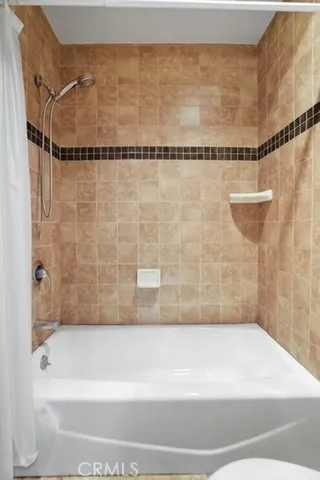 a bathroom with a shower and a bathtub