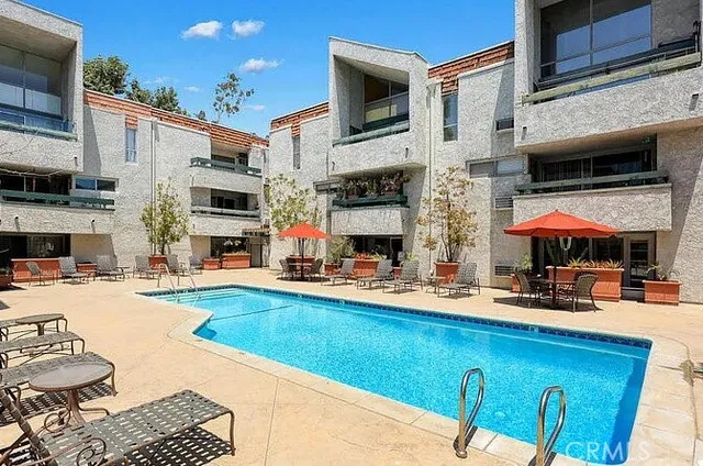 a swimming pool with outdoor seating and yard