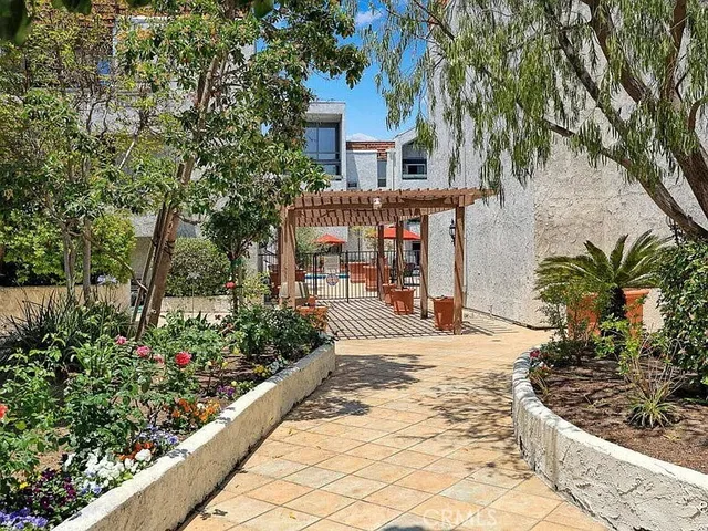 a front view of a house with a yard and a tree