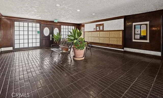 a lobby with furniture and potted plant