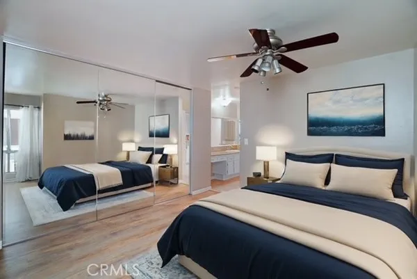 a bedroom with a large bed and a chandelier