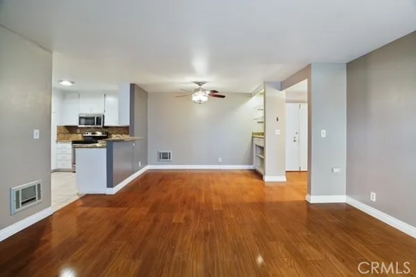 a view of a kitchen with a sink and wooden floor