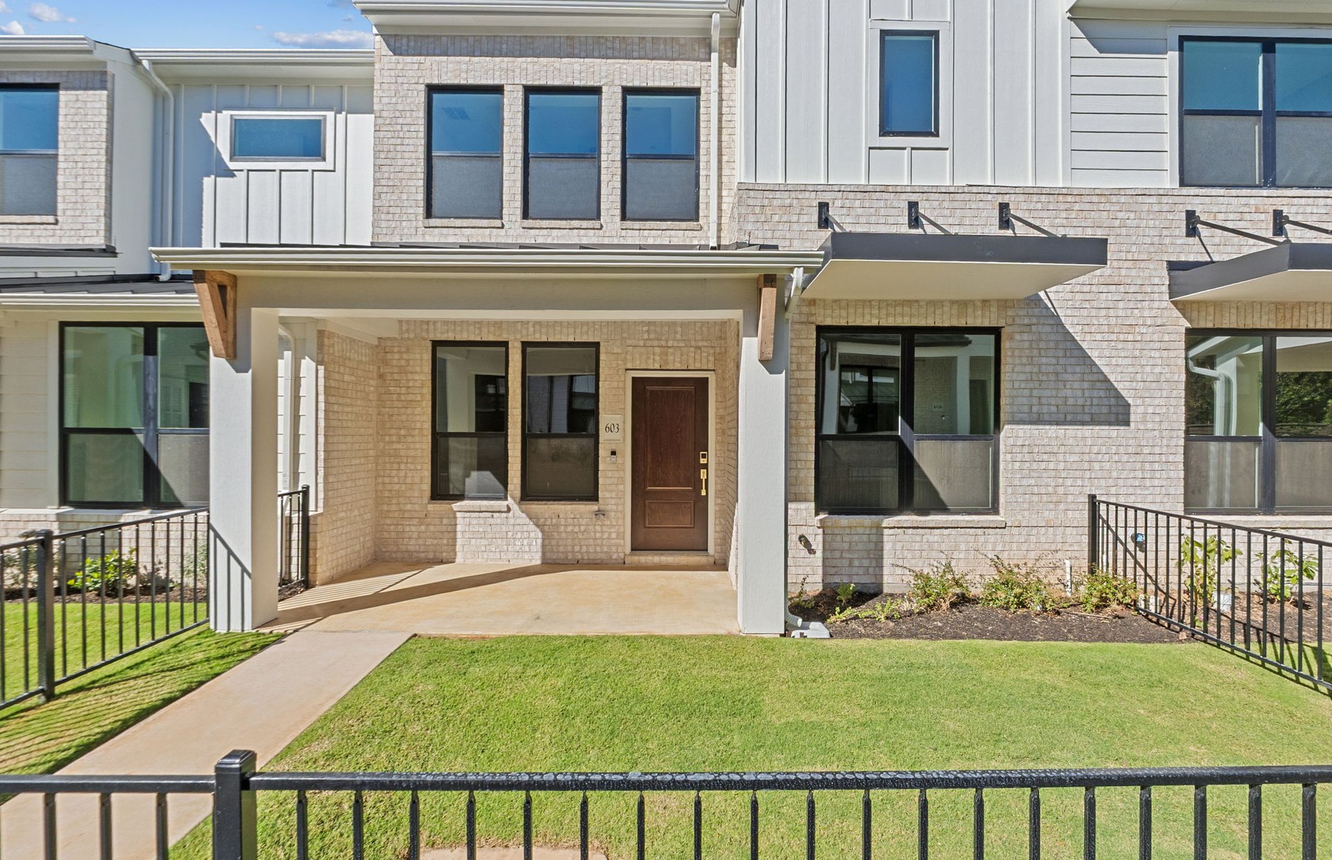 a view of a house with a yard and furniture