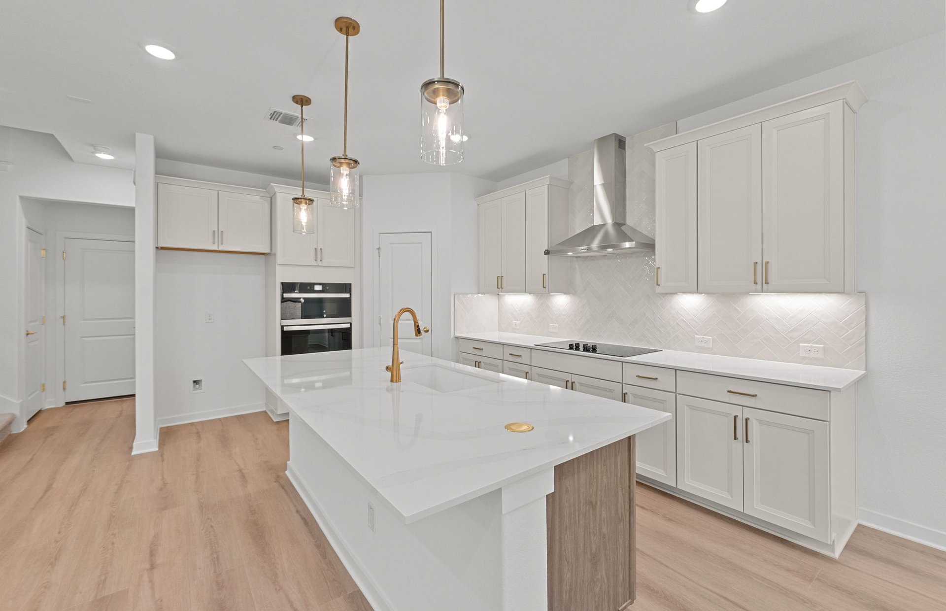 1280 East Main Street, Unit 603 Round Rock, TX 78664 - Photo 10 of 28 a large kitchen with stainless steel appliances granite countertop a lot of counter space and wooden floors