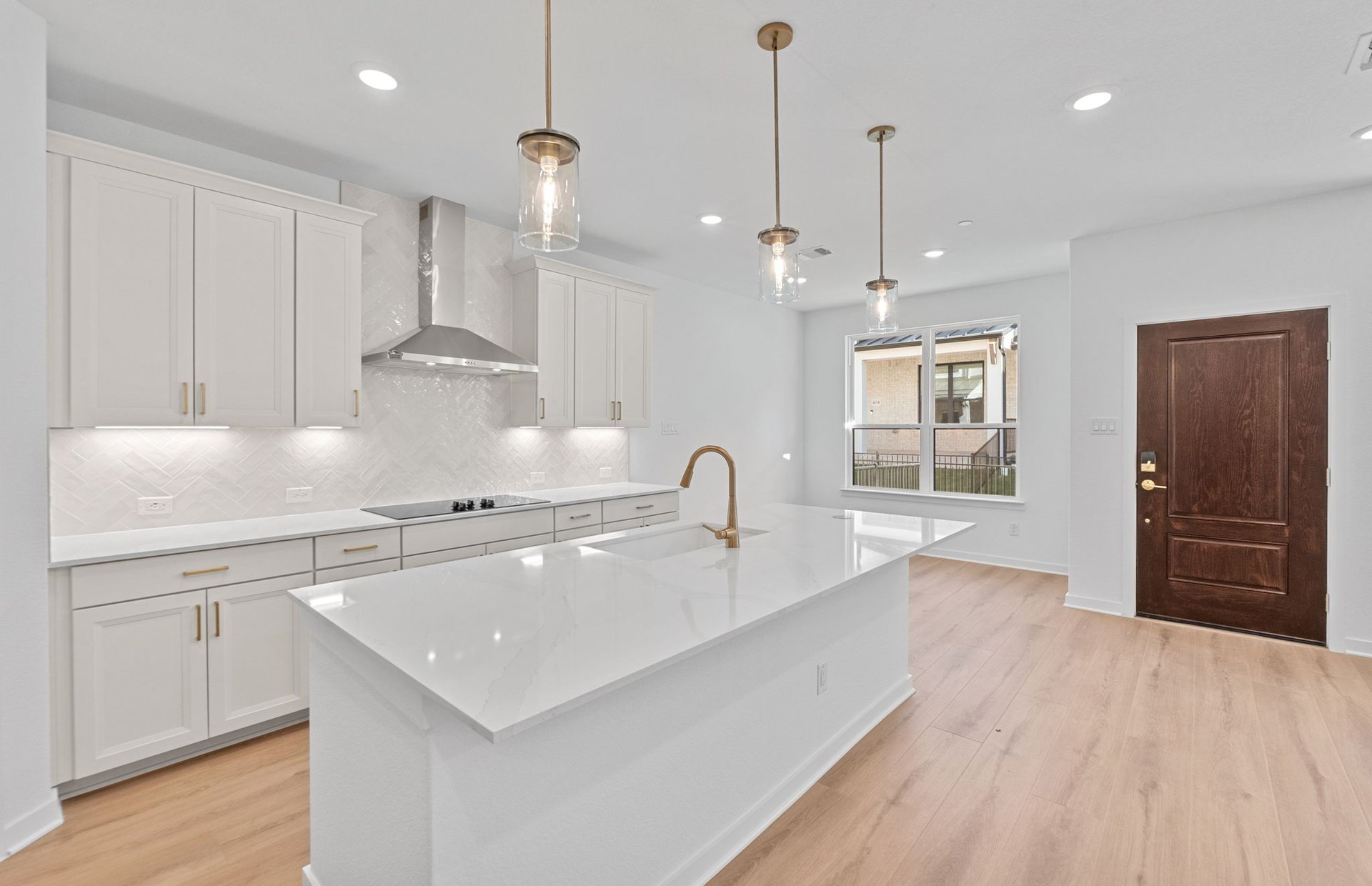 1280 East Main Street, Unit 603 Round Rock, TX 78664 - Photo 11 of 28 a large kitchen with kitchen island a sink stainless steel appliances and cabinets