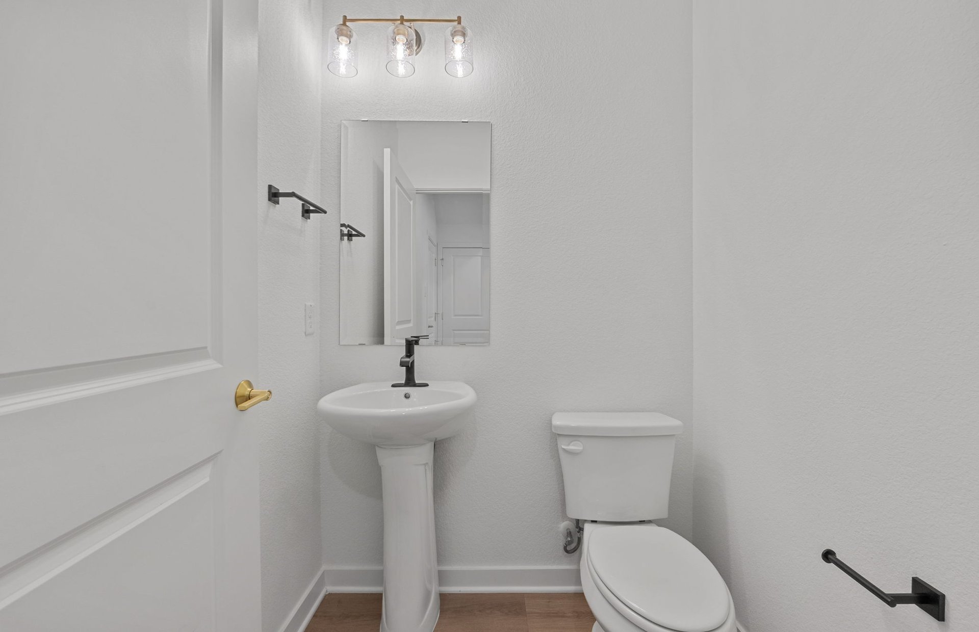 1280 East Main Street, Unit 603 Round Rock, TX 78664 - Photo 24 of 28 a bathroom with a sink a toilet and a mirror