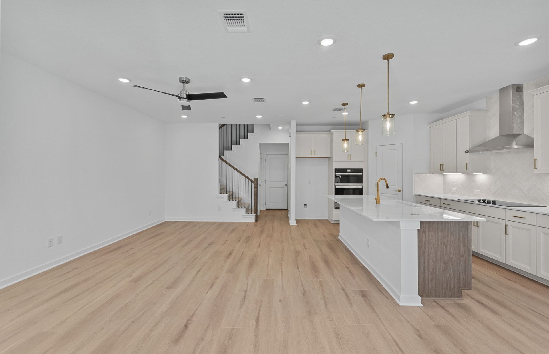 1280 East Main Street, Unit 603 Round Rock, TX 78664 - Photo 6 of 28 a large kitchen with stainless steel appliances kitchen island a large island in the center and wooden floors
