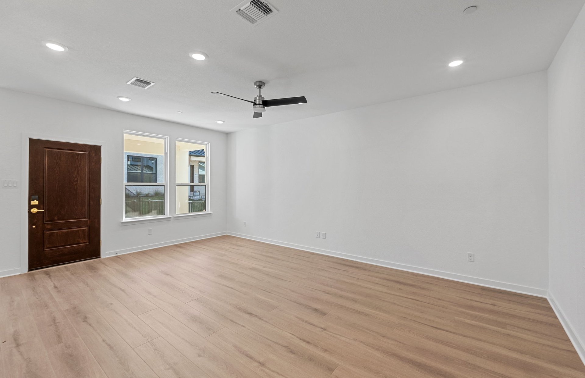 1280 East Main Street, Unit 603 Round Rock, TX 78664 - Photo 8 of 28 a view of an empty room with a window and wooden floor