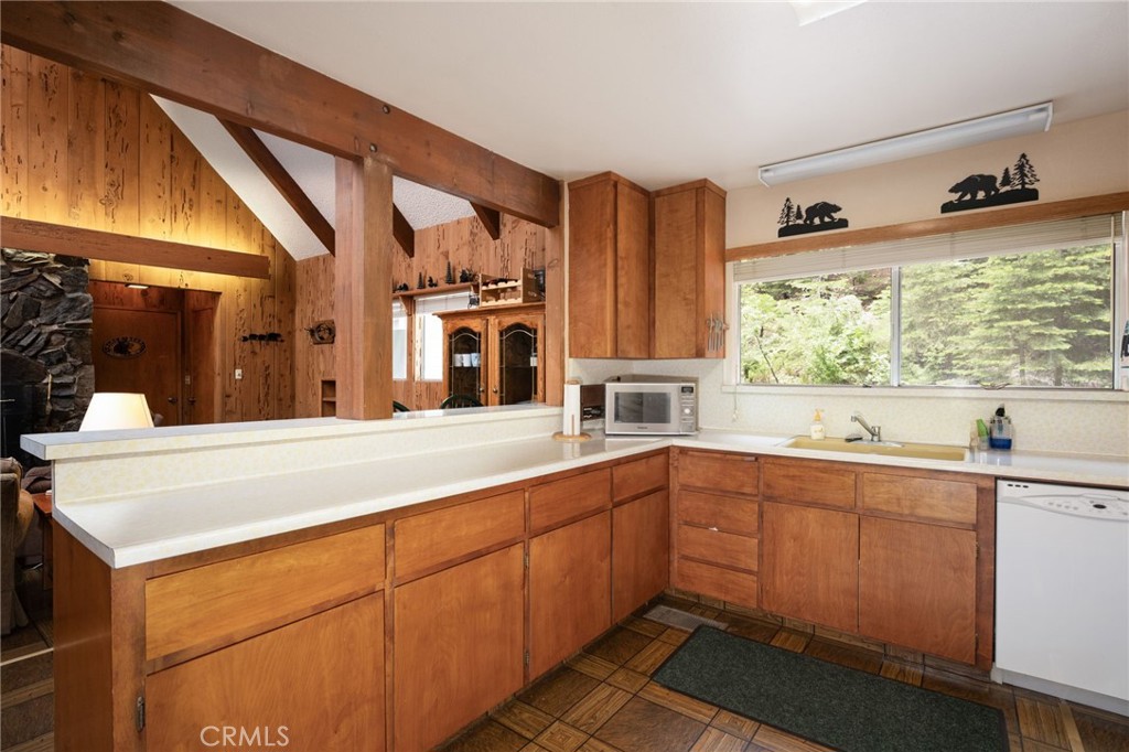 7663 Forest Drive Fish Camp, CA 93623 - Photo 11 of 43 a kitchen with stainless steel appliances a sink and cabinets