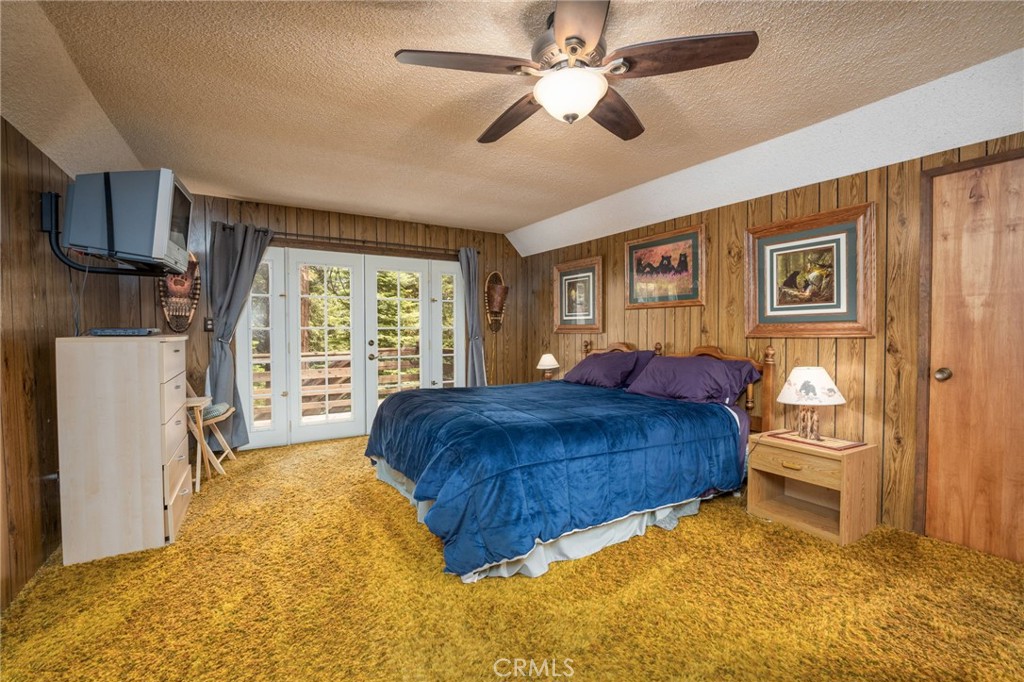 7663 Forest Drive Fish Camp, CA 93623 - Photo 22 of 43 a living room with a bed furniture and a large window