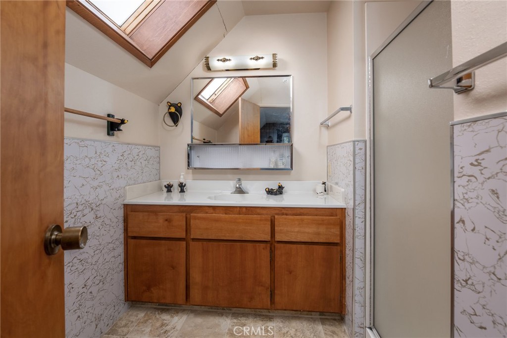 7663 Forest Drive Fish Camp, CA 93623 - Photo 24 of 43 a bathroom with a sink and a mirror