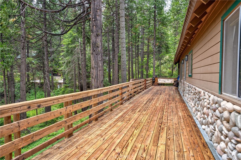 7663 Forest Drive Fish Camp, CA 93623 - Photo 31 of 43 a view of balcony with wooden floor and fence