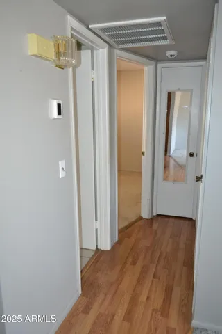 a view of a hallway with wooden floor